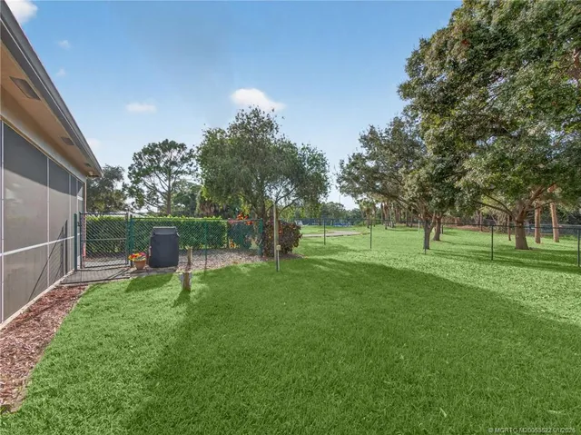 a view of house with backyard and a garden