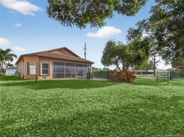a spacious bedroom with a large bed and a large window