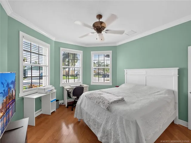 a bedroom with a large bed and a large window