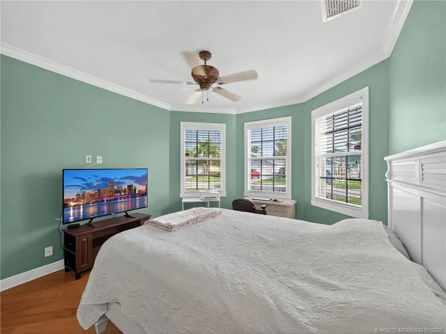 a bedroom with a bed and a large window