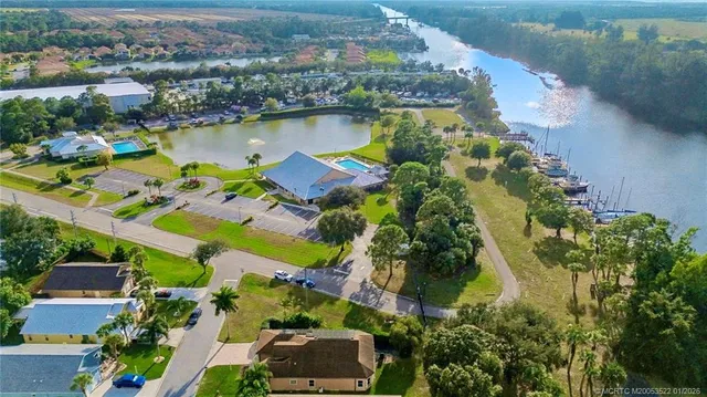an aerial view of house with yard swimming pool and lake view
