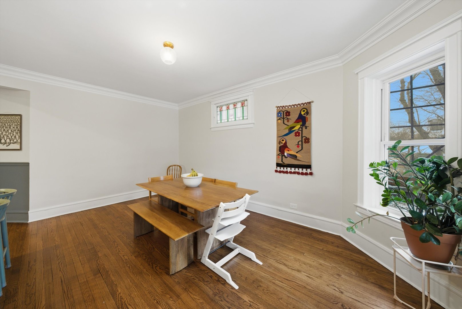 939 West Ainslie Street, Unit 2E Chicago, IL 60640 - Photo 26 of 47 a room with wooden floor and a potted plant