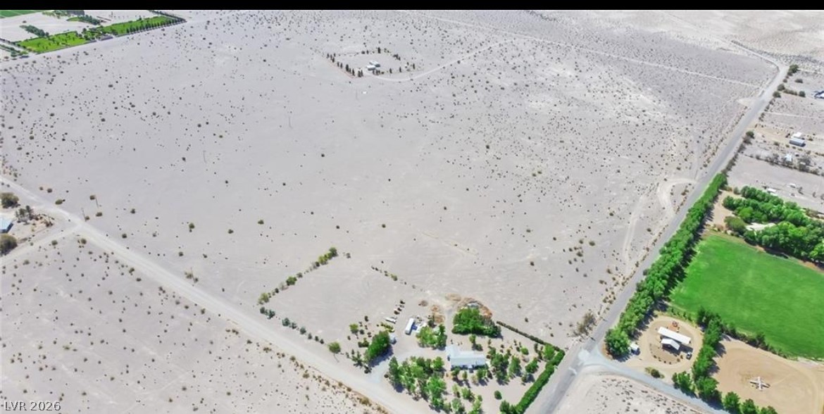 3699 South Miner Road Amargosa Valley, NV 89020 - Photo 2 of 6 Expansive desert acreage featuring a blend of arid landscapes and lush green parcels.