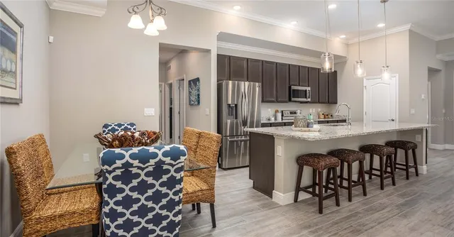 a kitchen with granite countertop a refrigerator and a stove top oven