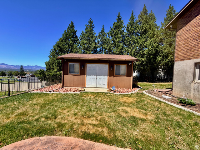 12080 Mill Ridge Circle Sandy, UT 84094 - Photo 39 of 56 Detached brown shed featuring double white doors and a side window