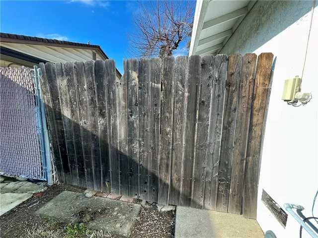 a view of a house with a wooden fence