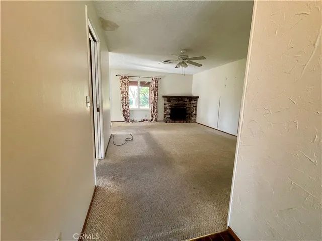 a view of empty room with a fireplace