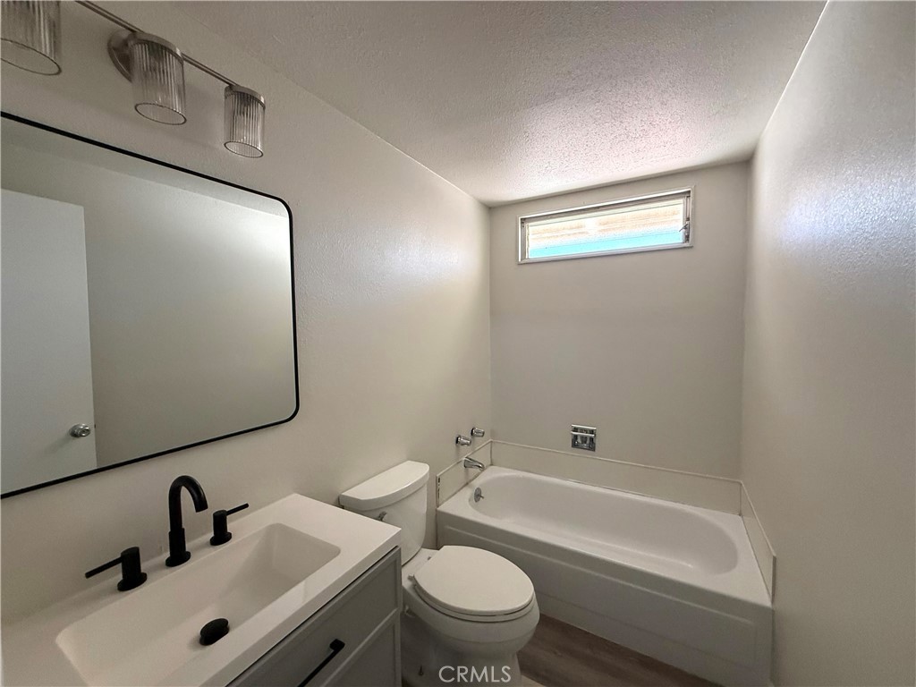 3445 Sparrow Circle Riverside, CA 92503 - Photo 20 of 41 a bathroom with a bathtub shower sink vanity mirror and toilet