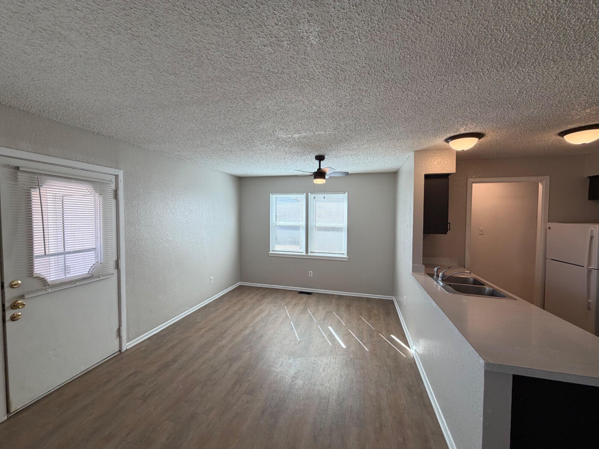 9604 Elgin Avenue, Unit B Lubbock, TX 79423 - Photo 3 of 12 wooden floor in an empty room with a window