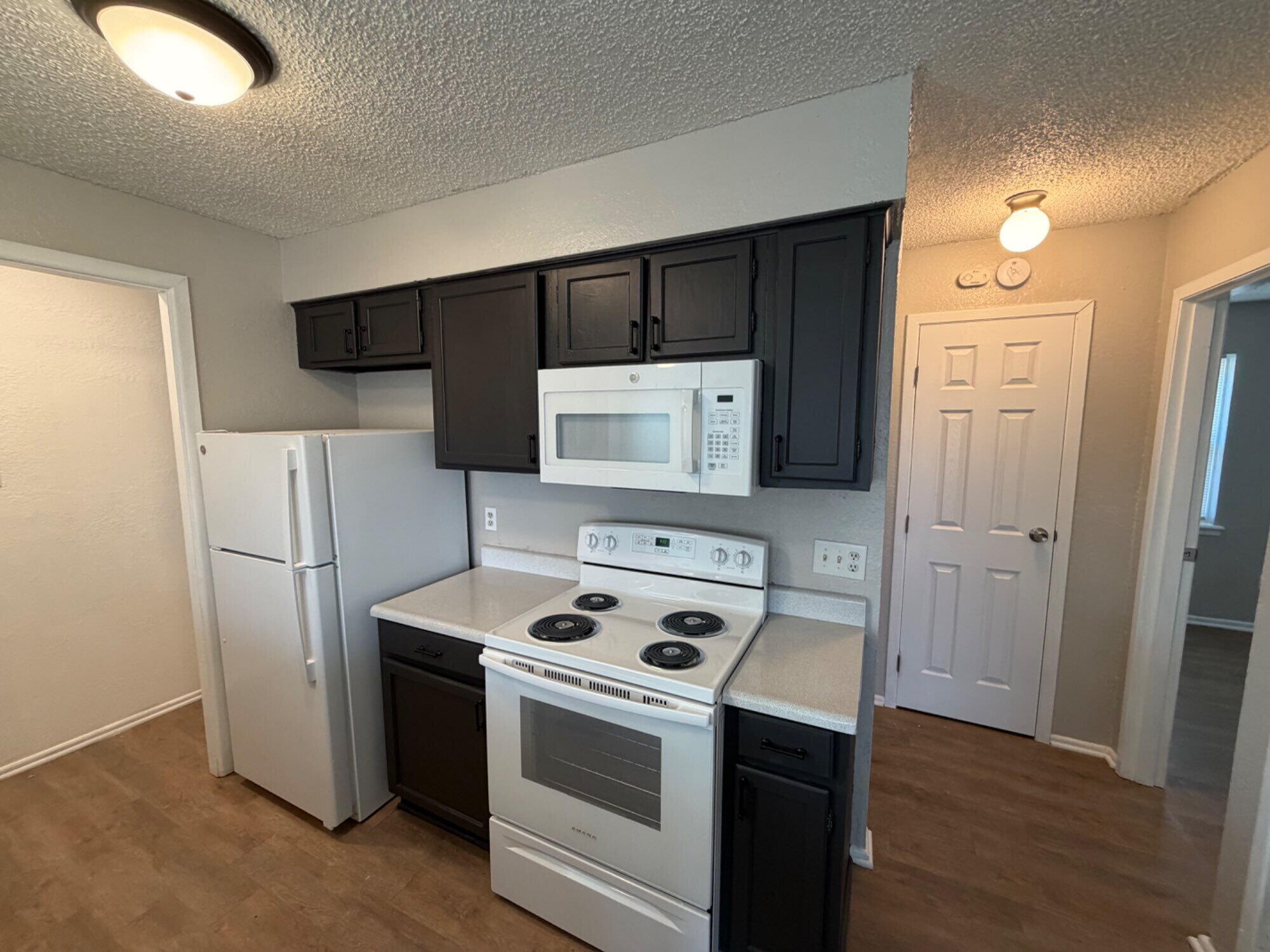 9604 Elgin Avenue, Unit B Lubbock, TX 79423 - Photo 5 of 12 a kitchen with a stove and a refrigerator
