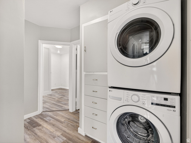 74 South 300 East Springville, UT 84663 - Photo 13 of 48 Dedicated laundry area featuring a stacked washer and dryer, white built-in cabinetry, and white baseboards