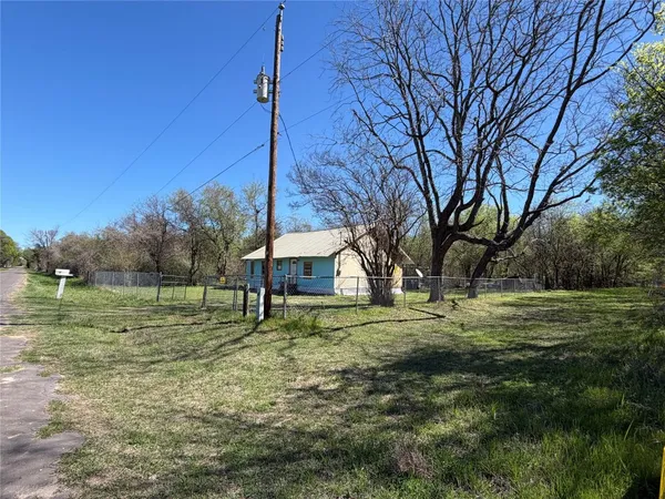 a view of a big yard with a tree