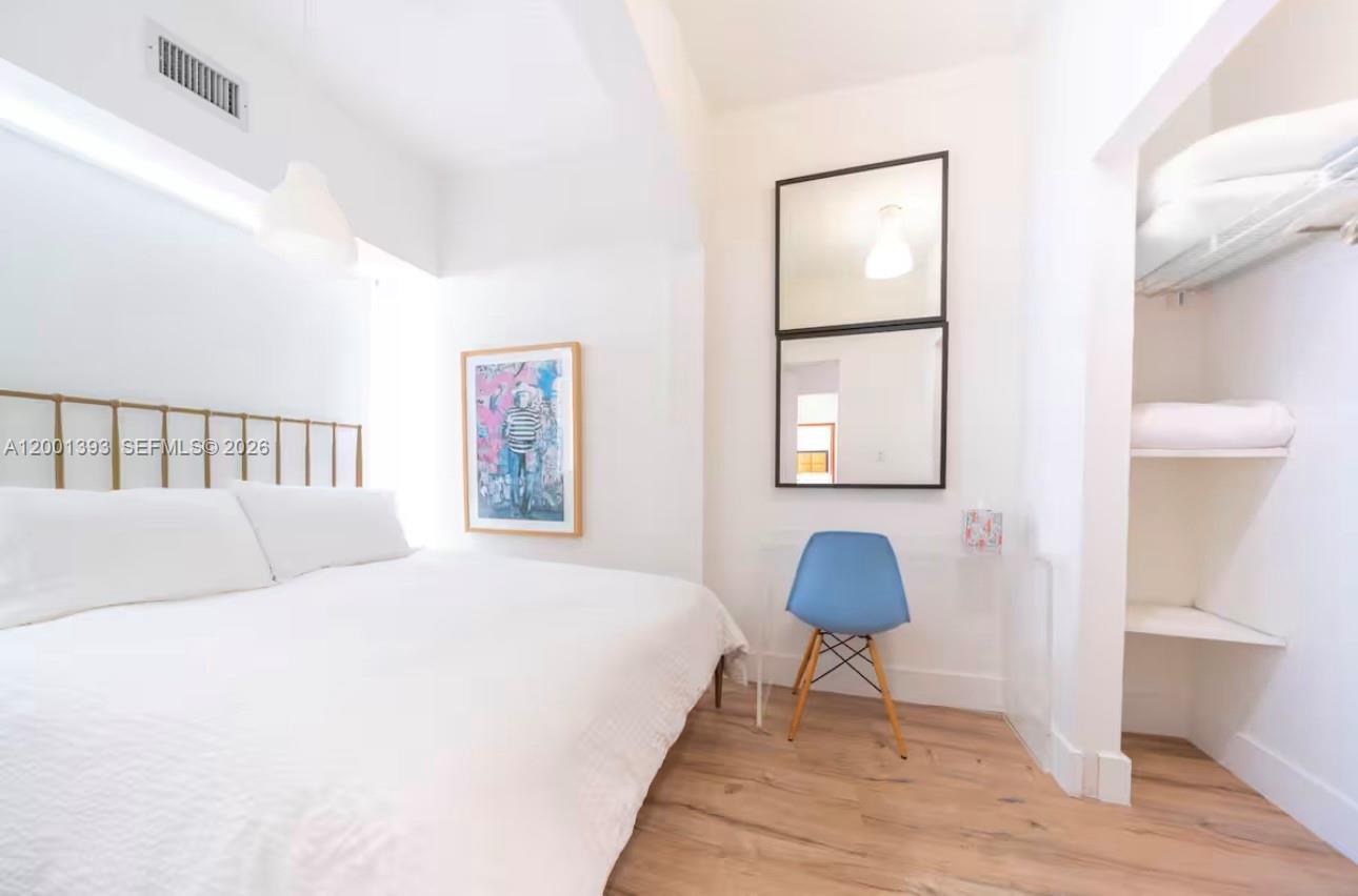 227 1st Street, Unit 7 Miami Beach, FL 33139 - Photo 11 of 12 a bedroom with a bed and a painting on the wall