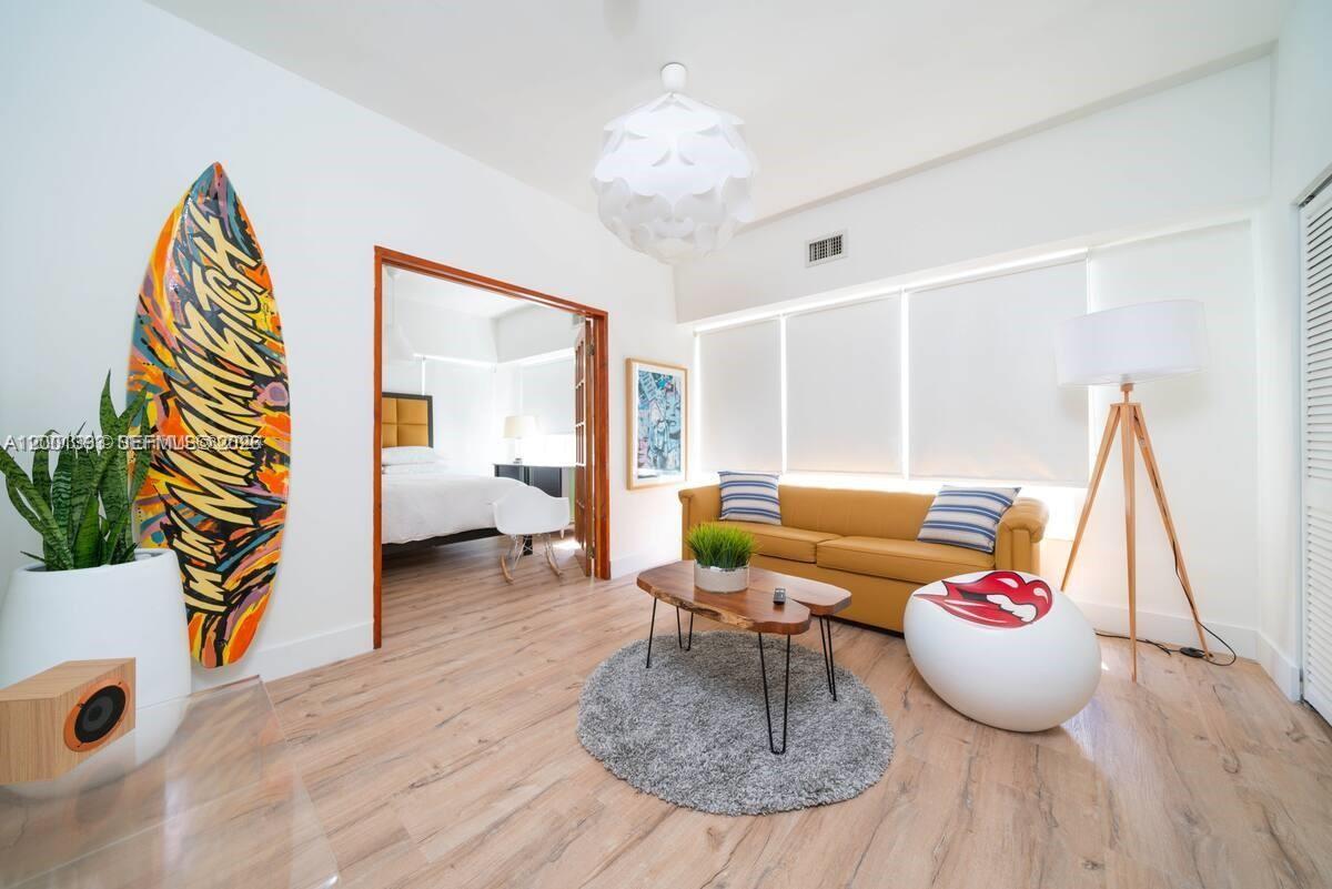 227 1st Street, Unit 7 Miami Beach, FL 33139 - Photo 2 of 12 a living room with furniture and a wooden floor