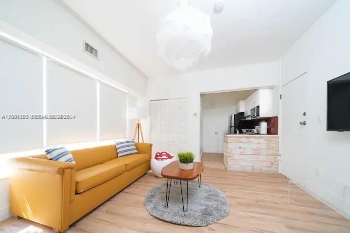 227 1st Street, Unit 7 Miami Beach, FL 33139 - Photo 3 of 12 a living room with furniture and a flat screen tv