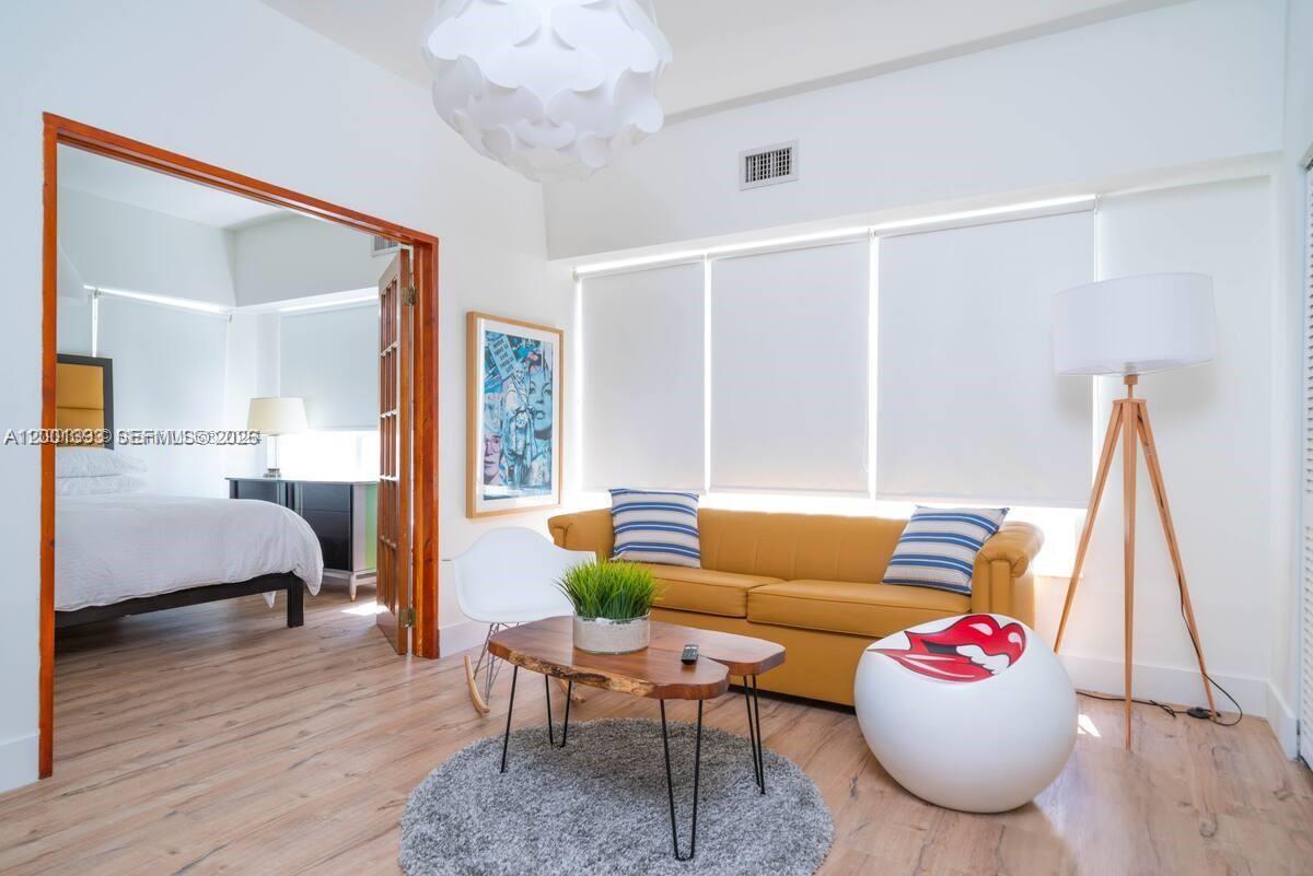 227 1st Street, Unit 7 Miami Beach, FL 33139 - Photo 5 of 12 a living room with furniture and a wooden floor
