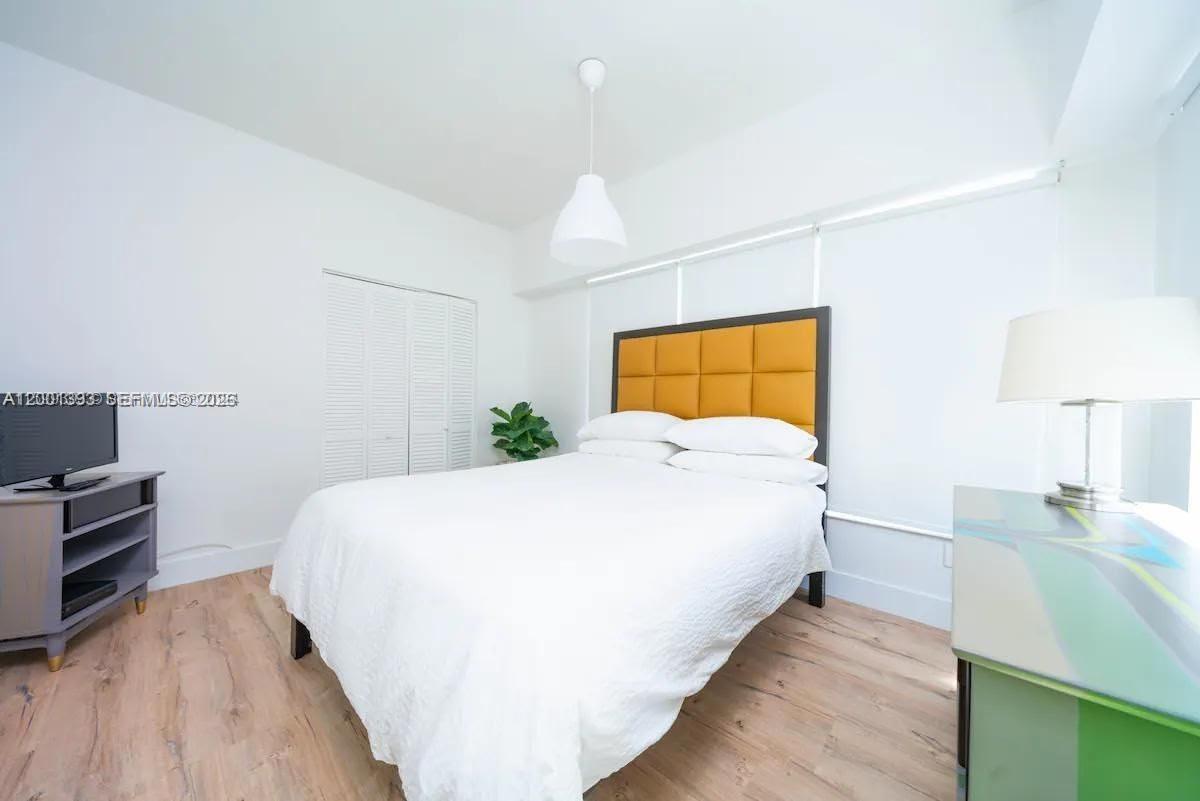 227 1st Street, Unit 7 Miami Beach, FL 33139 - Photo 6 of 12 a bed room with a bed and a night stand