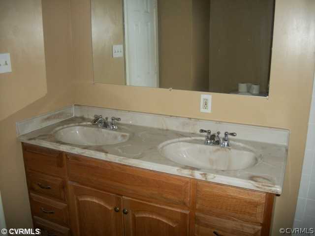 14121 Beach Road Chesterfield, VA 23838 - Photo 12 of 14 a bathroom with a granite countertop sink and a mirror