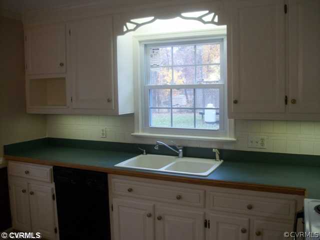 14121 Beach Road Chesterfield, VA 23838 - Photo 6 of 14 a kitchen with a sink window and cabinets