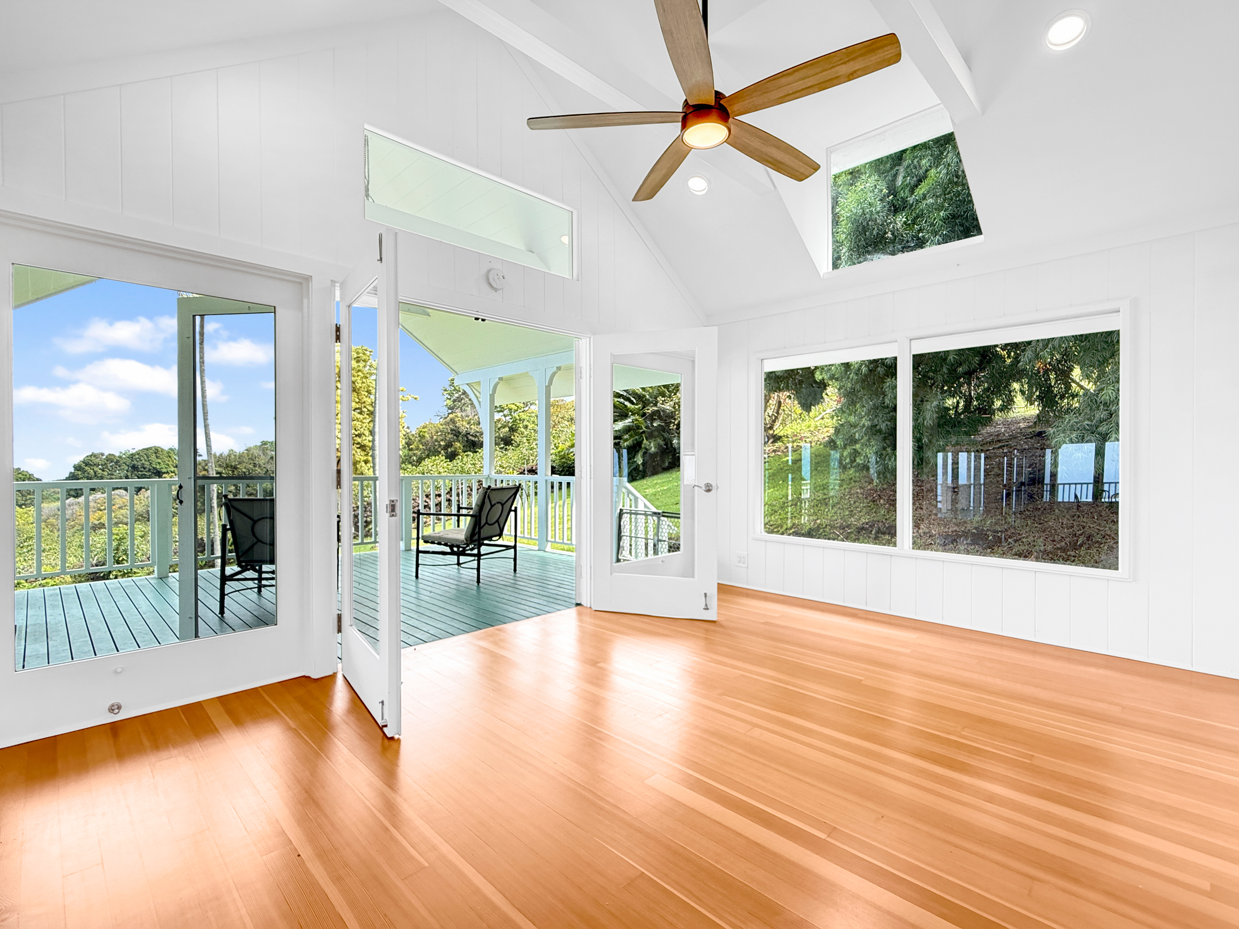 76-5807 Ho'okahi Road, Unit 1 Holualoa, HI 96725 - Photo 15 of 24 a view of an empty room with wooden floor and a window