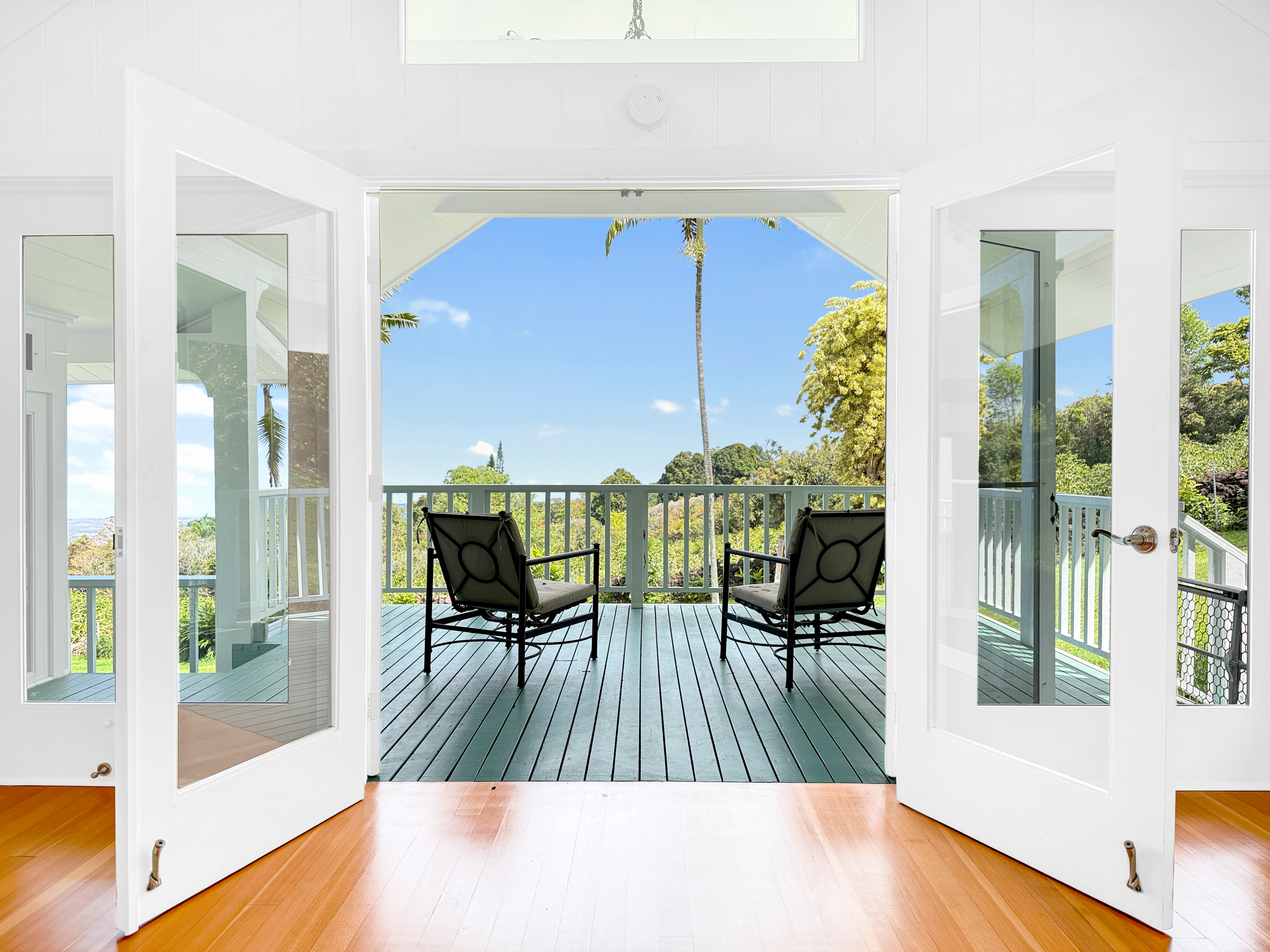 76-5807 Ho'okahi Road, Unit 1 Holualoa, HI 96725 - Photo 16 of 24 a view of a dining room with furniture a chandelier and wooden floor