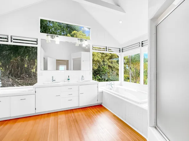 a bathroom with a sink mirror and a bathtub