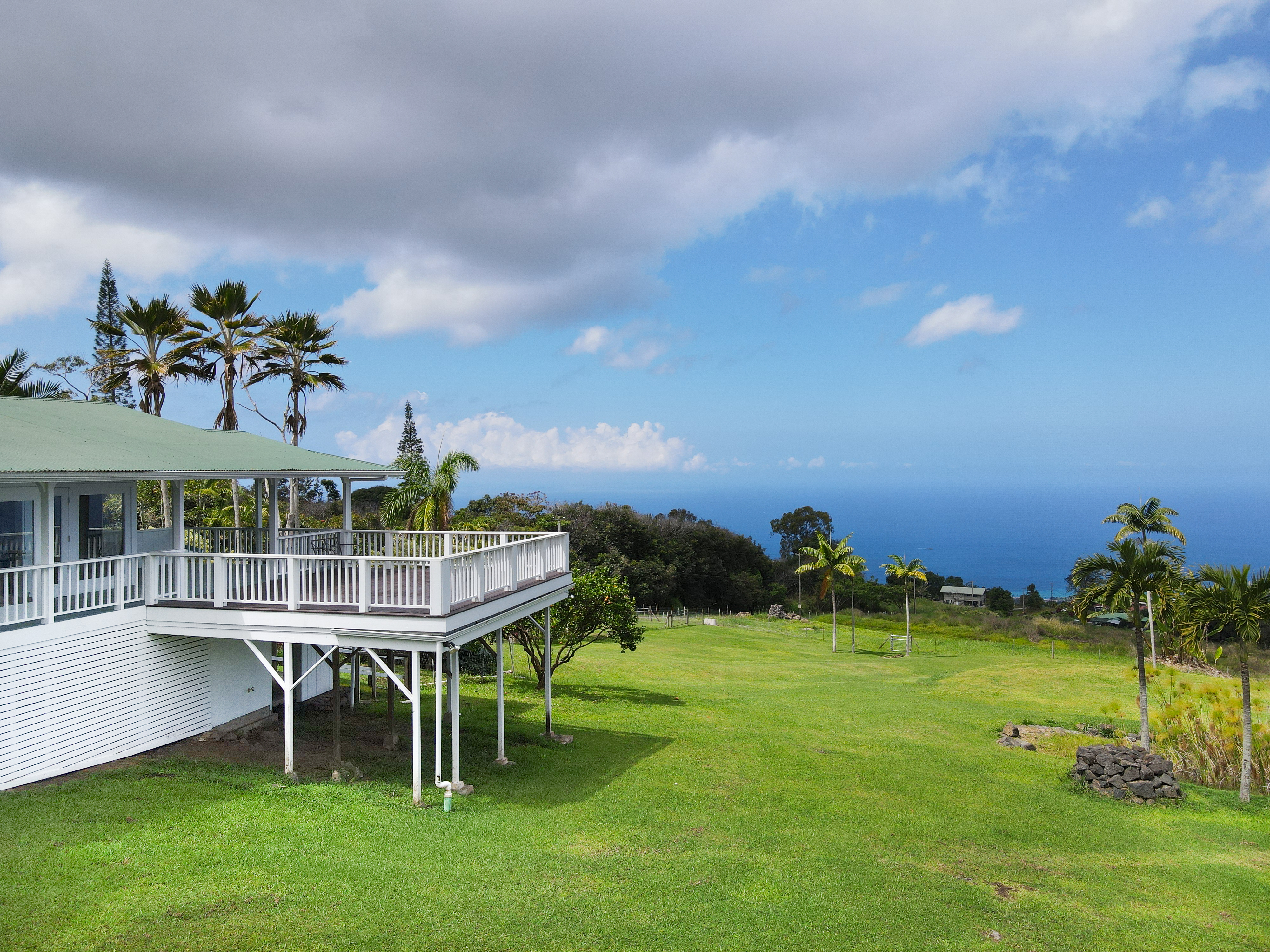 76-5807 Ho'okahi Road, Unit 1 Holualoa, HI 96725 - Photo 4 of 24 a view of a house with a backyard porch and sitting area