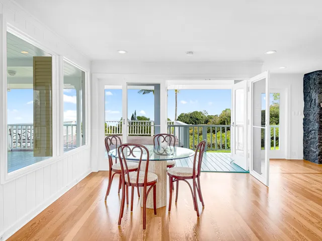 a view of a dining room with furniture and a potted plant