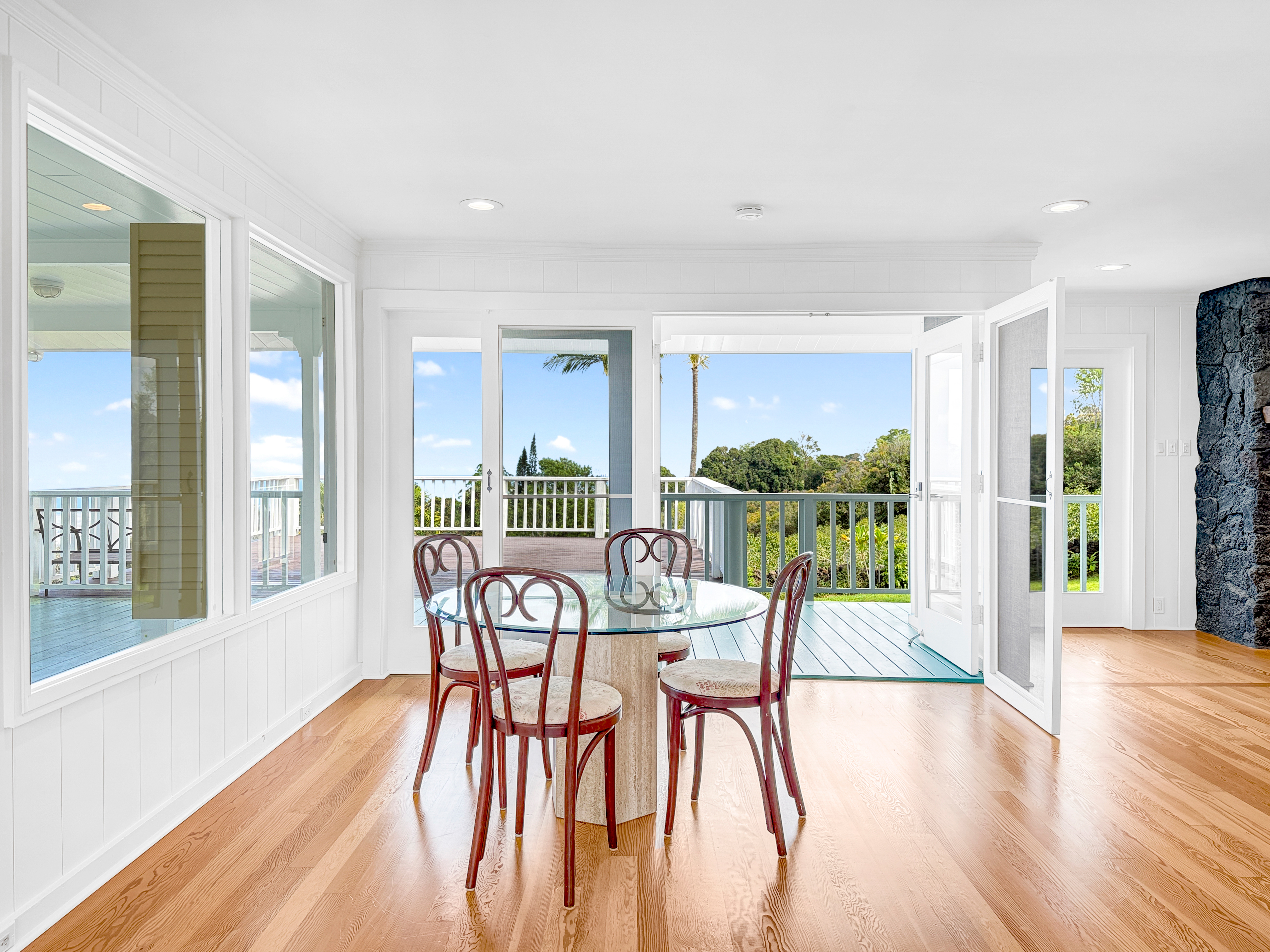 76-5807 Ho'okahi Road, Unit 1 Holualoa, HI 96725 - Photo 7 of 24 a view of a dining room with furniture and a potted plant