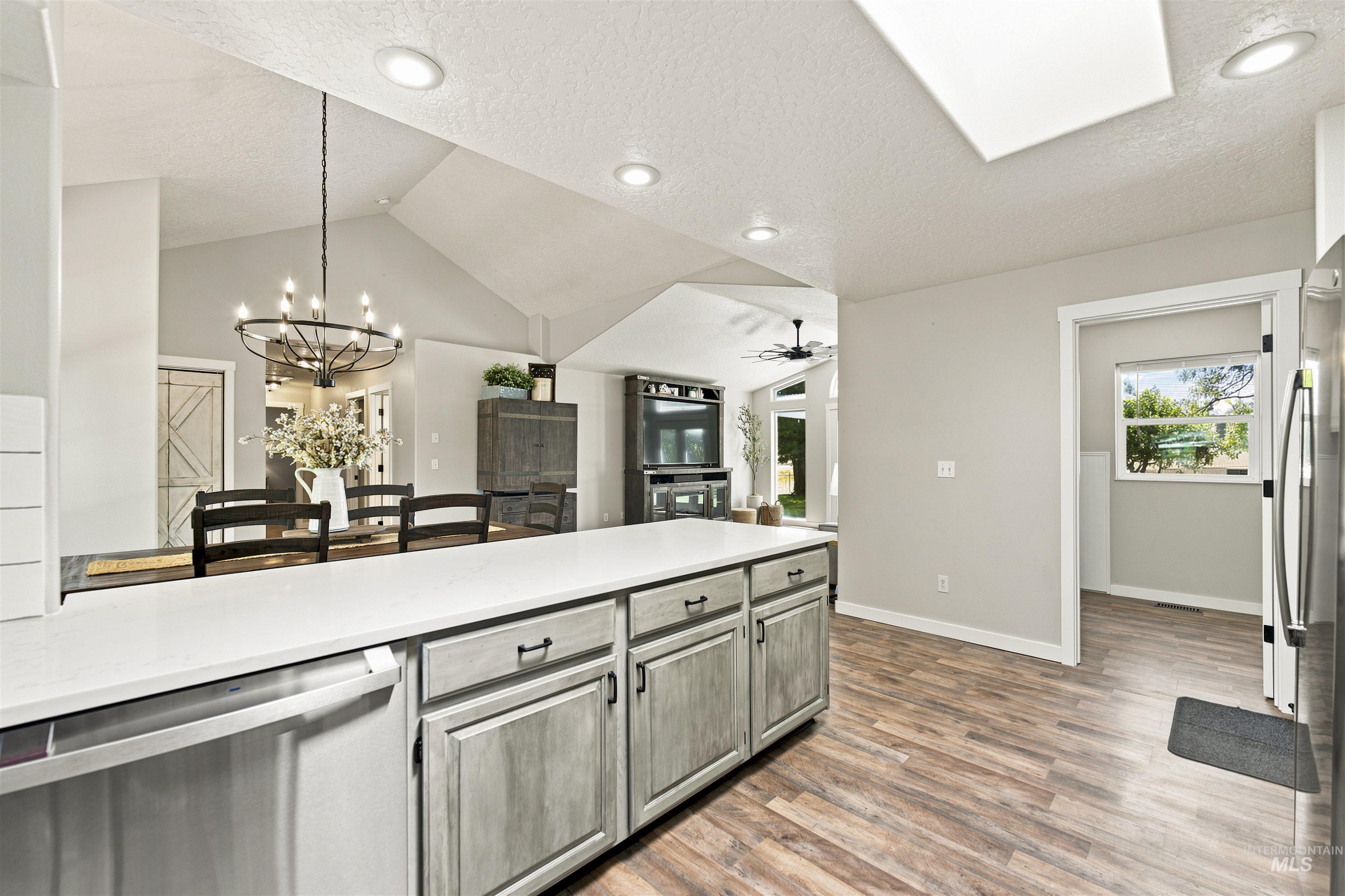 24864 Coventry Drive Caldwell, ID 83607 - Photo 14 of 49 Kitchen island with light-toned cabinetry and a white countertop