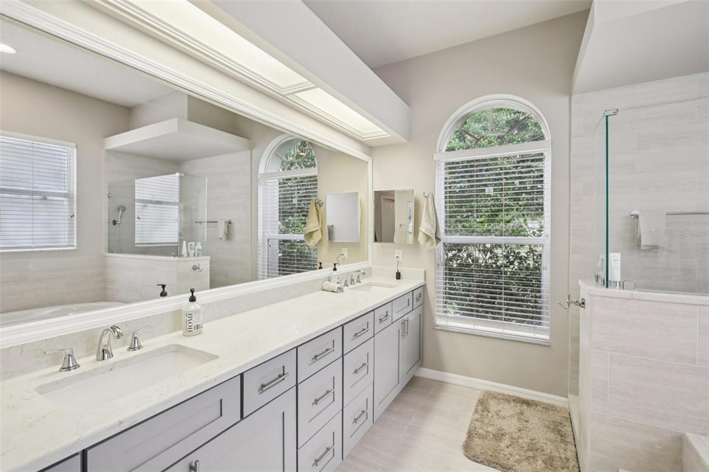 2903 Mossy Timber Trail Valrico, FL 33596 - Photo 16 of 39 a spacious bathroom with double vanity a window a double vanity sink and a bathtub