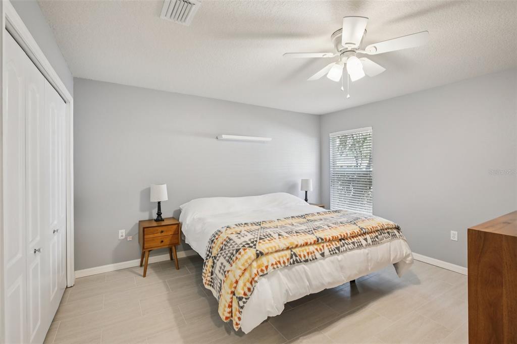 2903 Mossy Timber Trail Valrico, FL 33596 - Photo 22 of 39 a bedroom with a bed and a chandelier