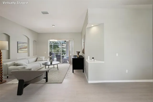 a living room with furniture and a large window