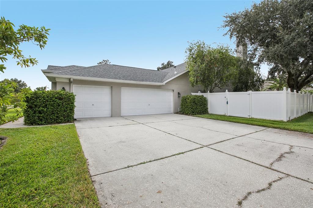 2903 Mossy Timber Trail Valrico, FL 33596 - Photo 32 of 39 a front view of a house with a yard and garage