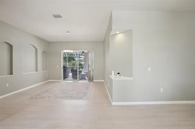 a view of a big room with windows and chandelier