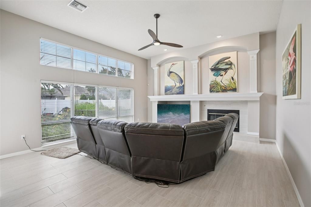 2903 Mossy Timber Trail Valrico, FL 33596 - Photo 5 of 39 a living room with furniture a large window and a fireplace
