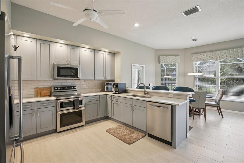 2903 Mossy Timber Trail Valrico, FL 33596 - Photo 10 of 39 a kitchen with sink cabinets and stainless steel appliances