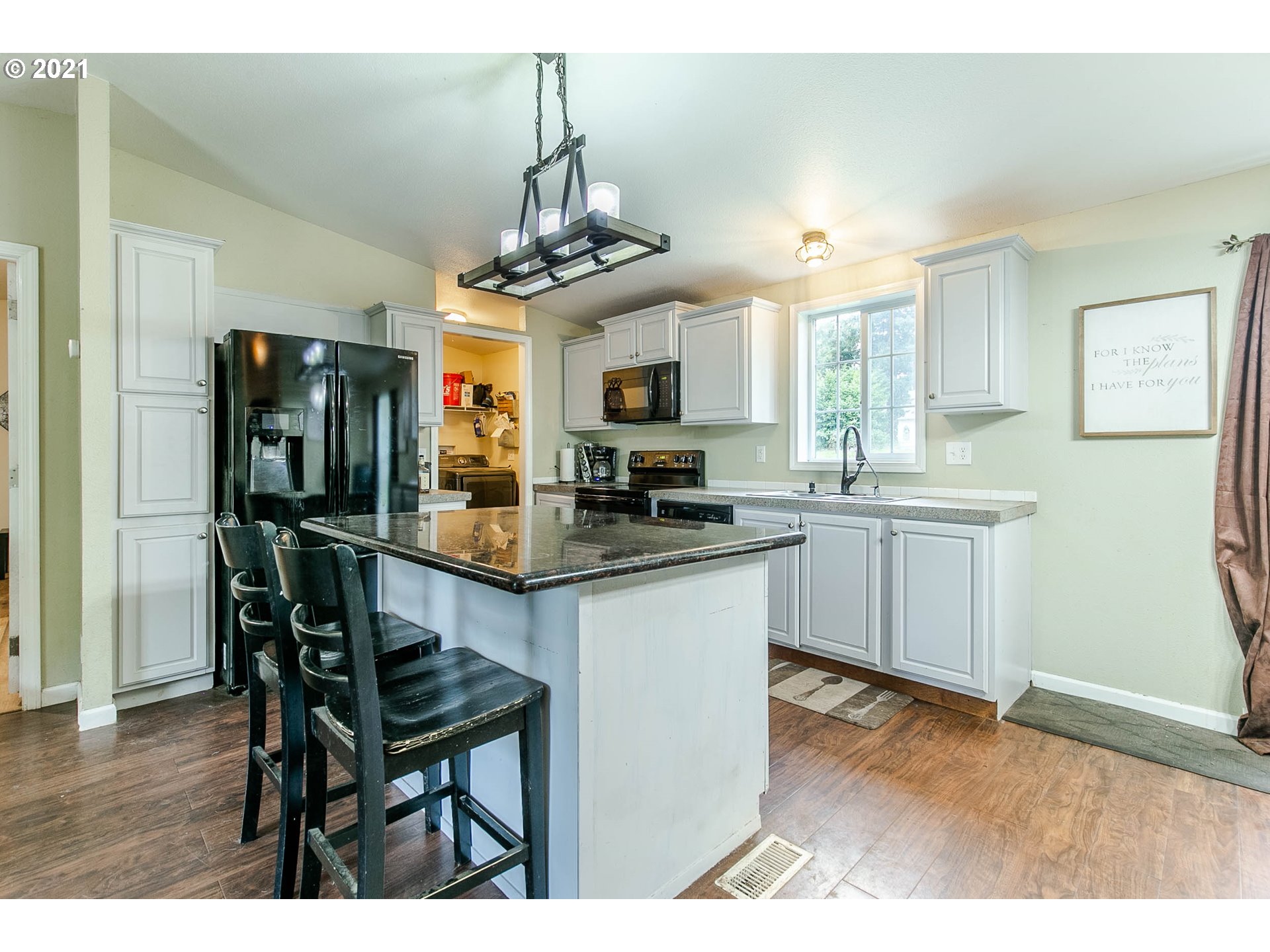 38075 Wheeler Road Dexter, OR 97431 - Photo 12 of 32 a kitchen with stainless steel appliances granite countertop a refrigerator a stove a sink dishwasher a dining table and chairs with wooden floor