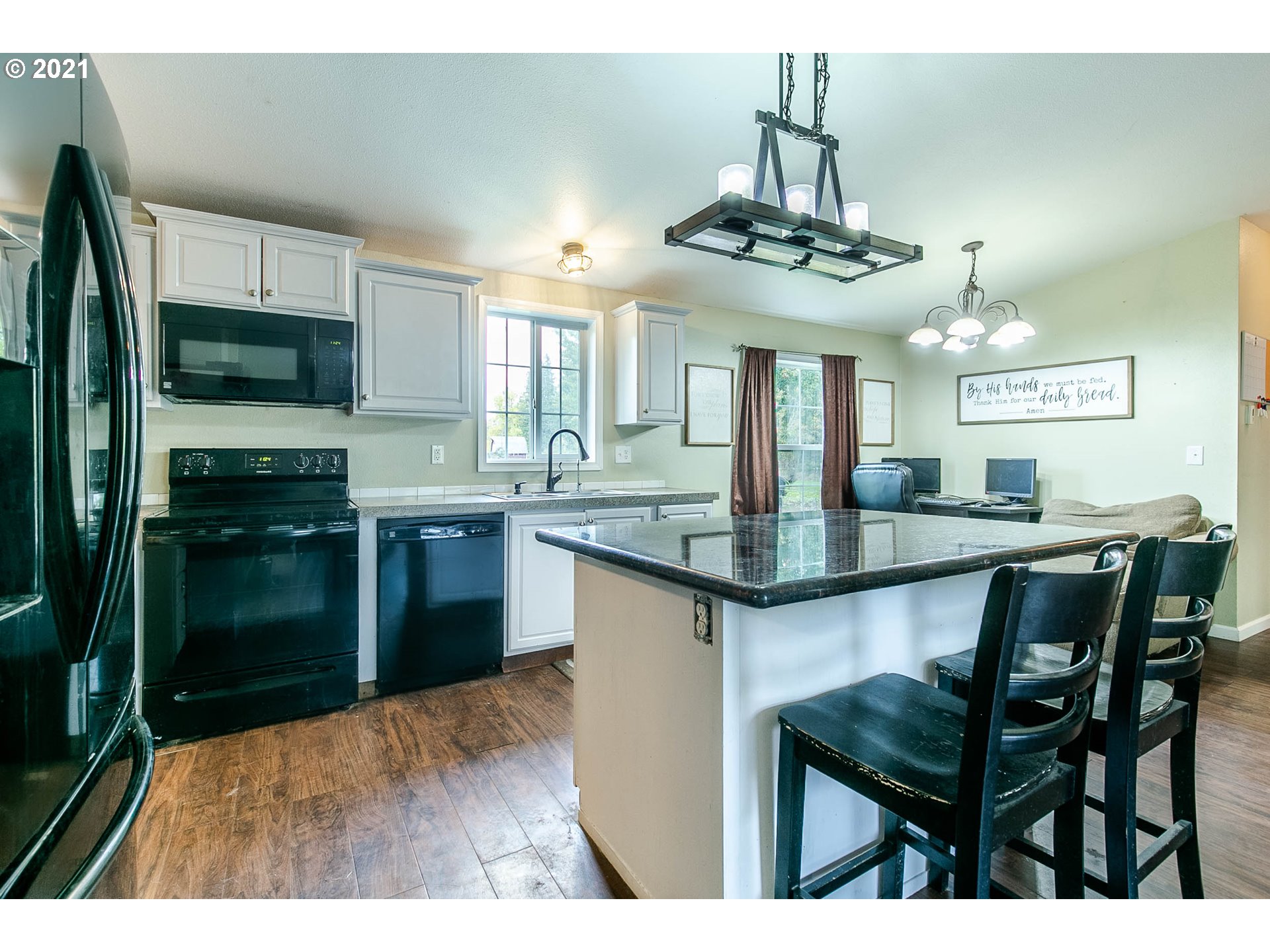 38075 Wheeler Road Dexter, OR 97431 - Photo 13 of 32 a kitchen with stainless steel appliances granite countertop a sink a stove top oven a counter space and cabinets