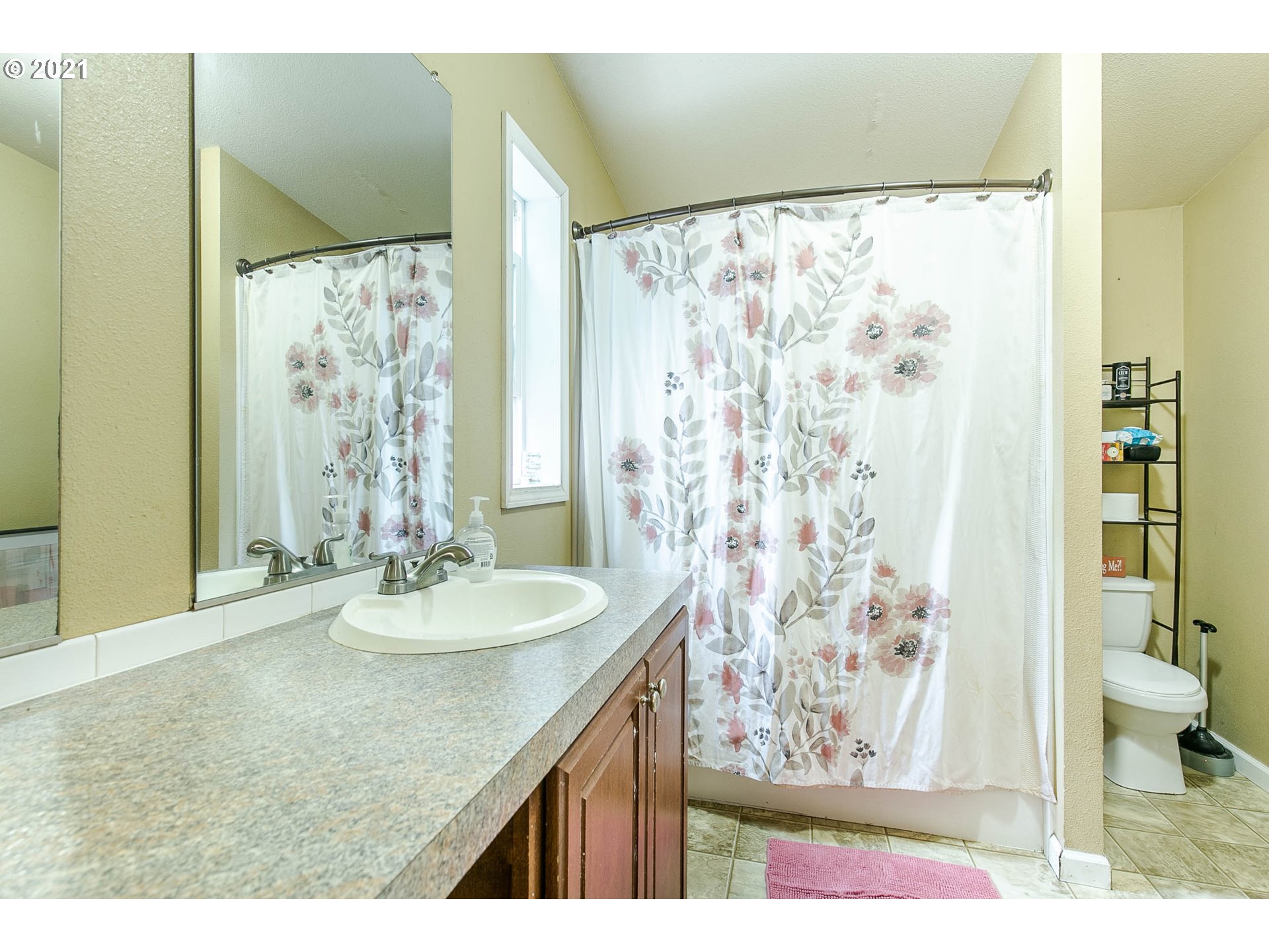 38075 Wheeler Road Dexter, OR 97431 - Photo 18 of 32 a bathroom with a granite countertop sink a toilet and shower curtain