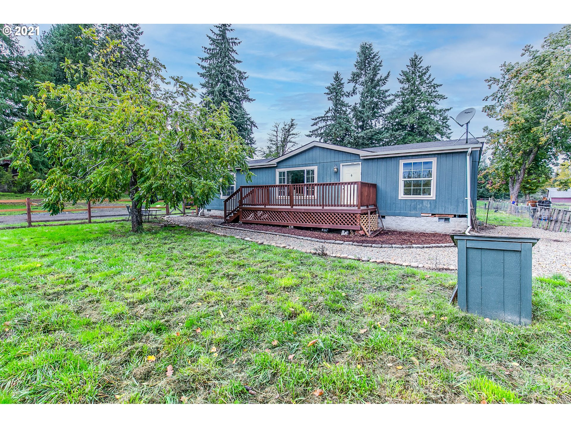 38075 Wheeler Road Dexter, OR 97431 - Photo 5 of 32 a front view of a house with a yard and trees