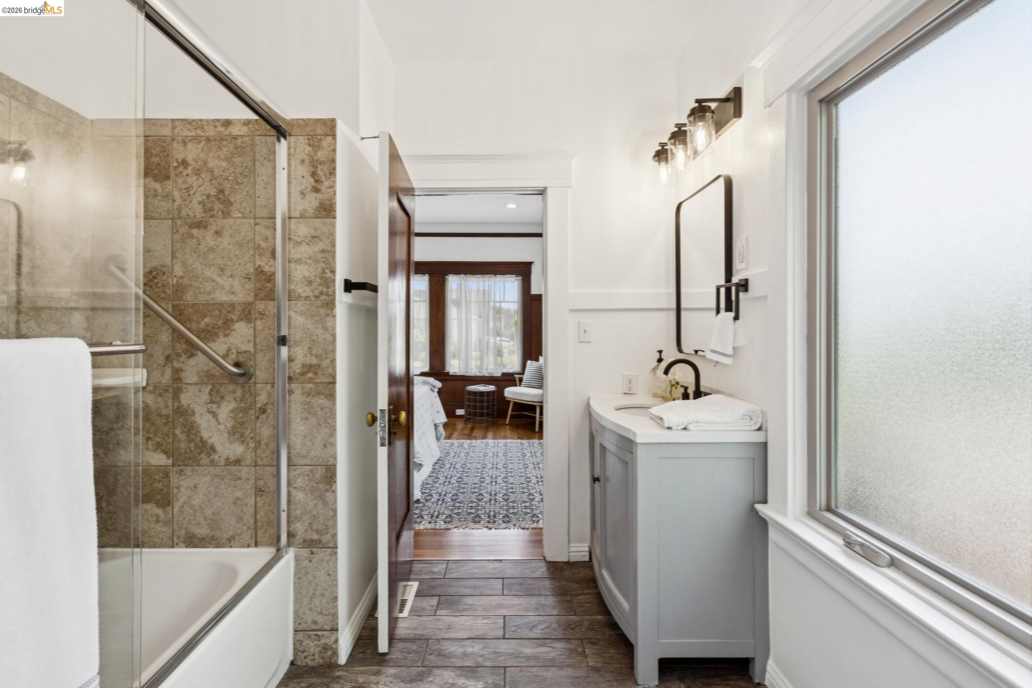 1701 Derby Street Berkeley, CA 94703 - Photo 26 of 39 Bathroom featuring a full tub with a glass shower enclosure and tiled surround