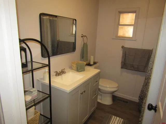 a bathroom with a sink toilet and mirror