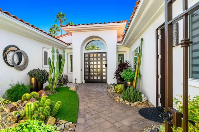 a kitchen with stainless steel appliances granite countertop a dining table and chairs in it