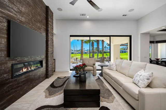 a living room with fireplace furniture and a flat screen tv