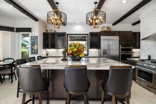 a view of a swimming pool with a patio and a yard