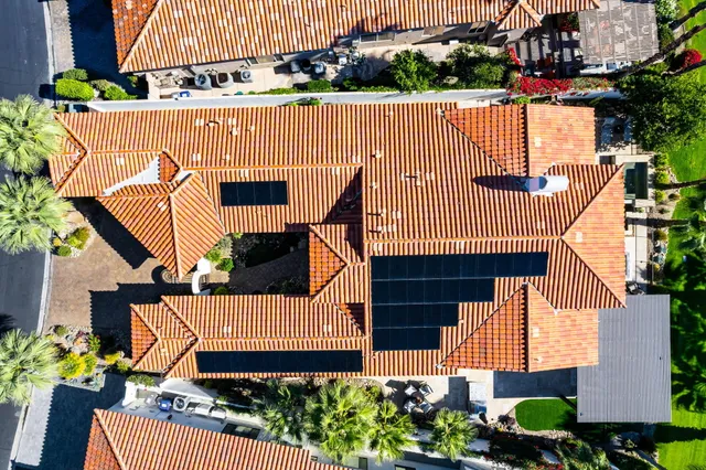 a bathroom with a granite countertop sink a mirror and shower