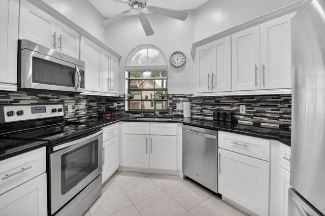 a kitchen with stainless steel appliances a stove a sink and a microwave