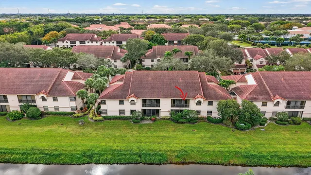 a swimming pool with outdoor seating and outdoor shower
