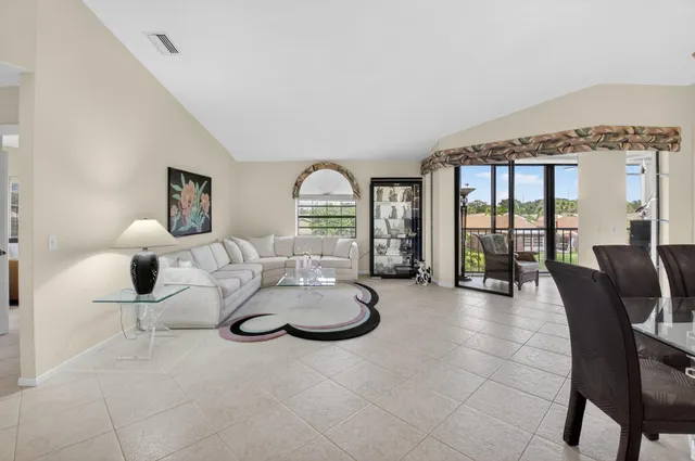 a dining room with furniture a chandelier and fireplace